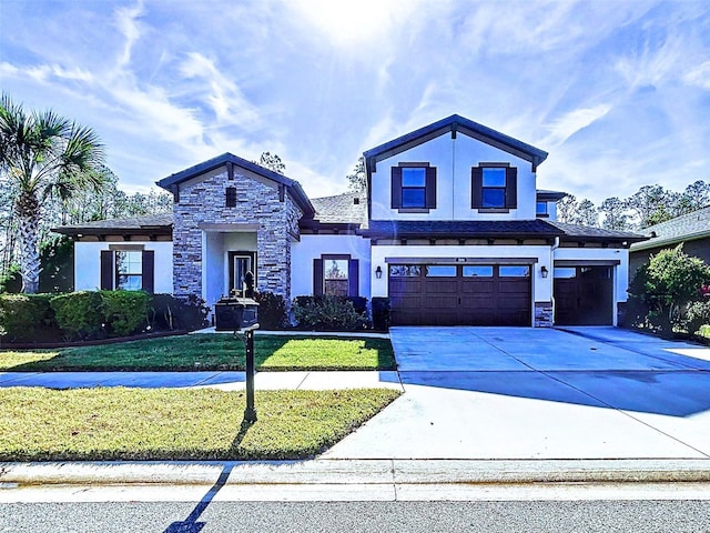 view of front of home with a front yard and a garage