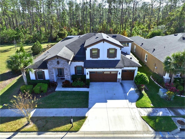 view of front of house with a garage and a front yard