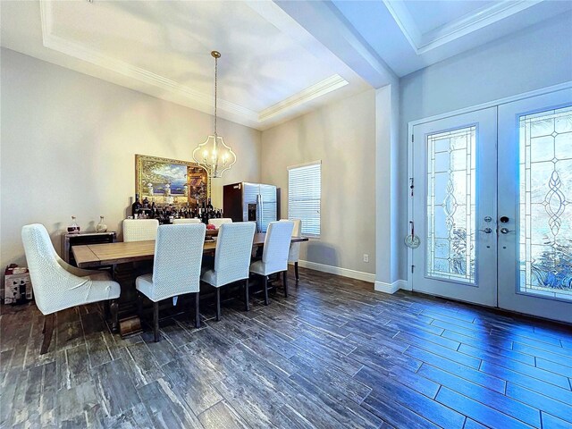 dining space featuring a wealth of natural light, dark hardwood / wood-style flooring, crown molding, and french doors