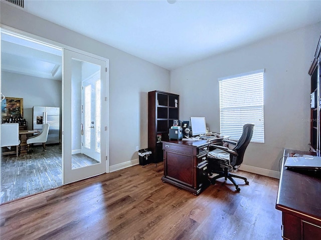 home office with french doors, dark hardwood / wood-style flooring, and a healthy amount of sunlight