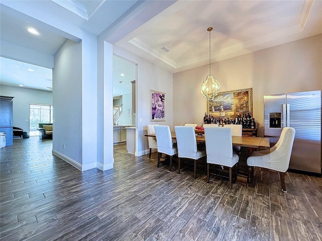 dining space featuring dark hardwood / wood-style floors and crown molding