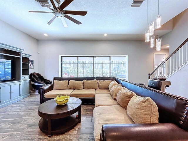 living room with ceiling fan and wood-type flooring