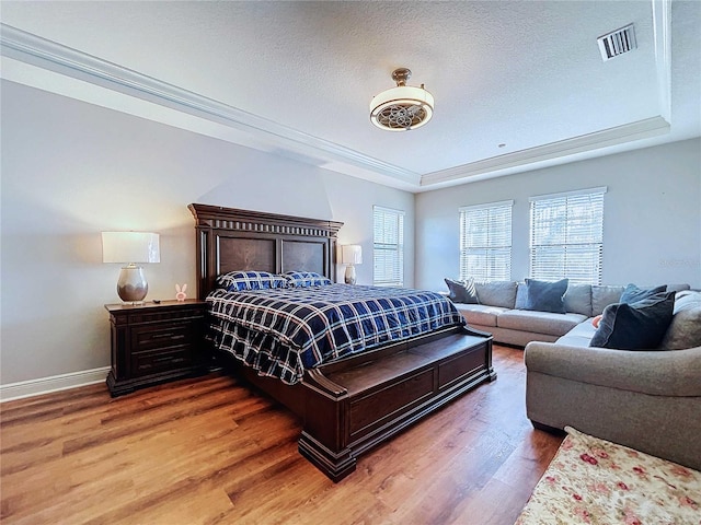 bedroom with hardwood / wood-style floors and a textured ceiling