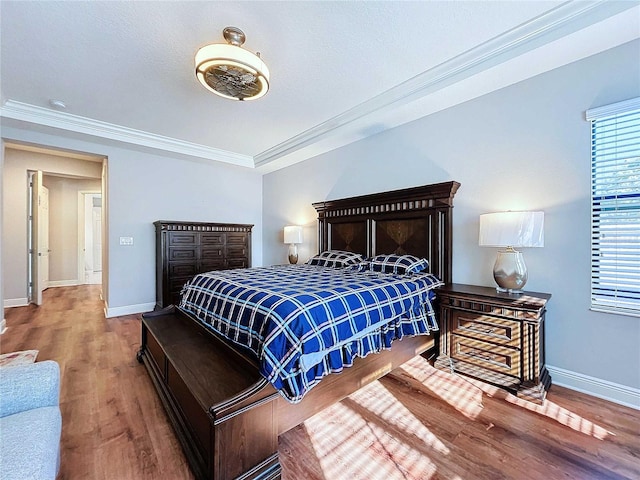 bedroom featuring crown molding and hardwood / wood-style floors