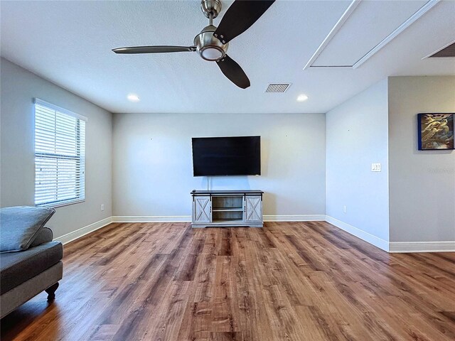 unfurnished living room with hardwood / wood-style flooring and ceiling fan