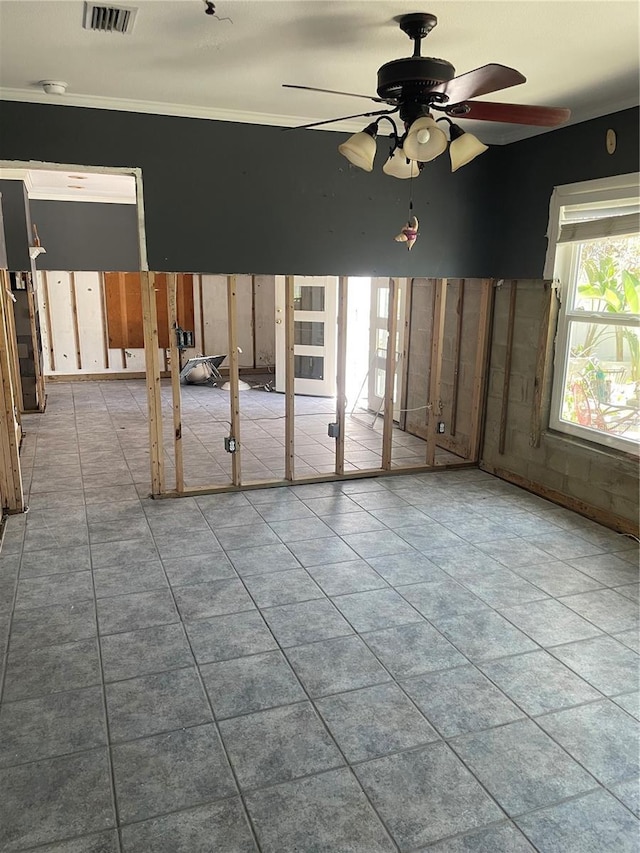 909 Mandalay Ave, Clearwater Beach, FL 33767 - tiled empty room with visible vents, ceiling fan, and ornamental molding