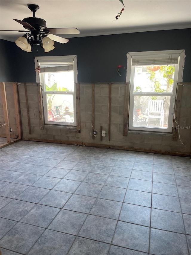 909 Mandalay Ave, Clearwater Beach, FL 33767 - unfurnished room with tile patterned flooring, ceiling fan, and a healthy amount of sunlight