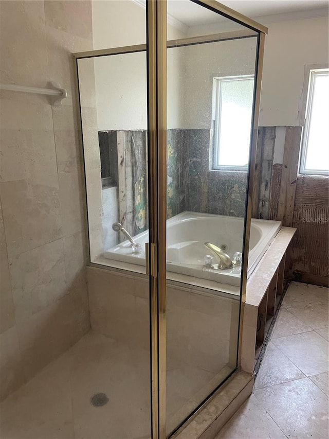 909 Mandalay Ave, Clearwater Beach, FL 33767 - bathroom featuring a garden tub, a stall shower, and a wealth of natural light