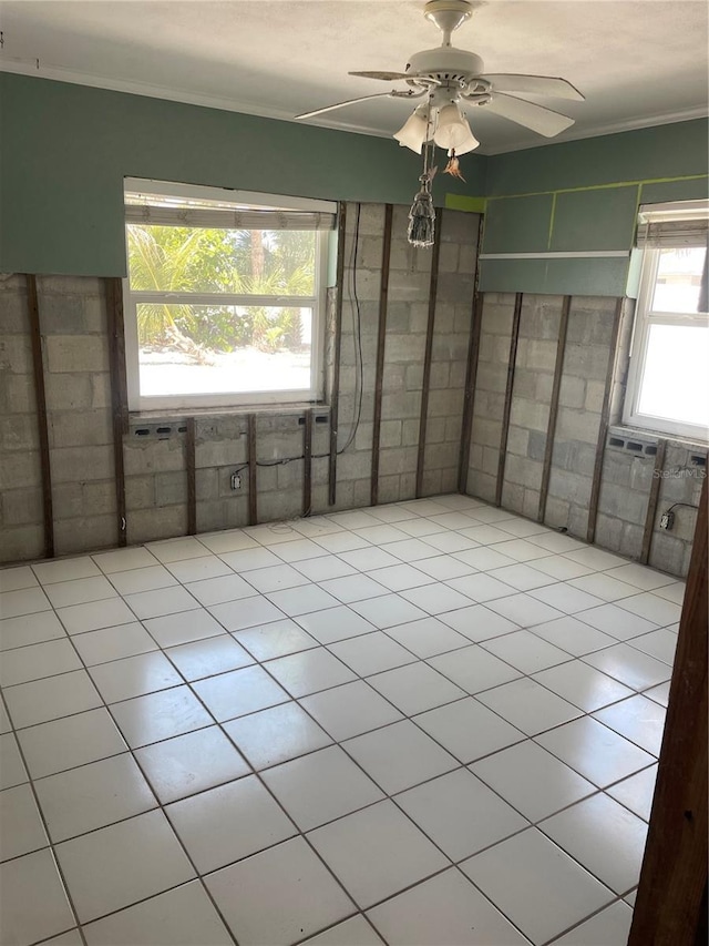 909 Mandalay Ave, Clearwater Beach, FL 33767 - empty room featuring ceiling fan, ornamental molding, and tile patterned flooring