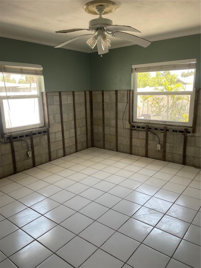 909 Mandalay Ave, Clearwater Beach, FL 33767 - empty room with a healthy amount of sunlight, a ceiling fan, and ornamental molding