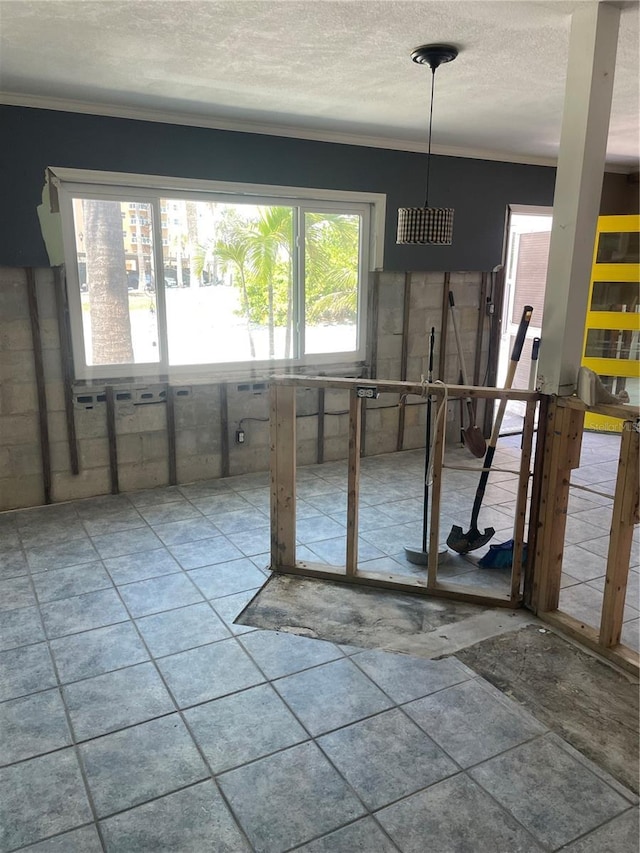 909 Mandalay Ave, Clearwater Beach, FL 33767 - unfurnished dining area featuring ornamental molding and a textured ceiling