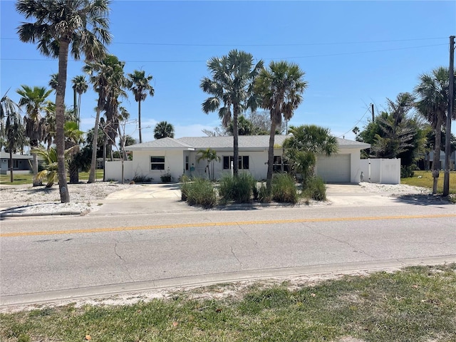909 Mandalay Ave, Clearwater Beach, FL 33767 - ranch-style home featuring a garage, fence, stucco siding, and concrete driveway