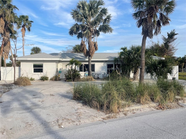 909 Mandalay Ave, Clearwater Beach, FL 33767 - ranch-style house featuring fence and stucco siding