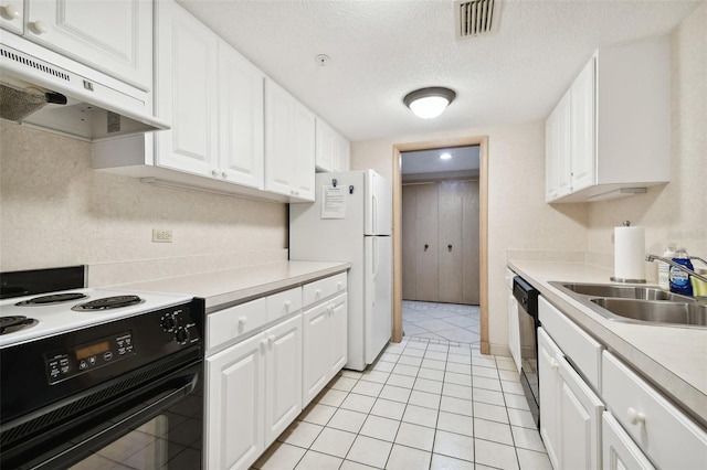 kitchen with electric range oven, sink, white cabinets, white fridge, and range hood