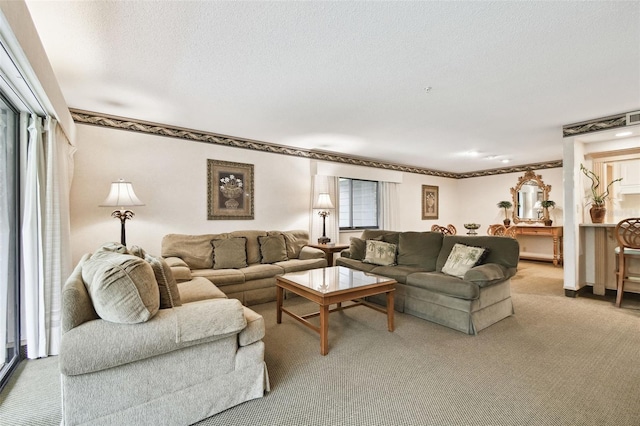 living room with light colored carpet and a textured ceiling