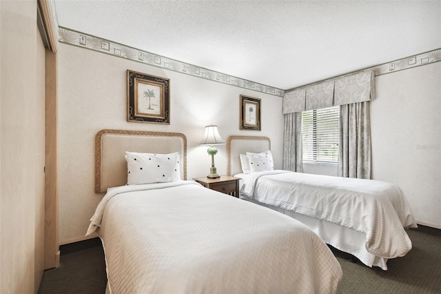 carpeted bedroom featuring a closet and a textured ceiling