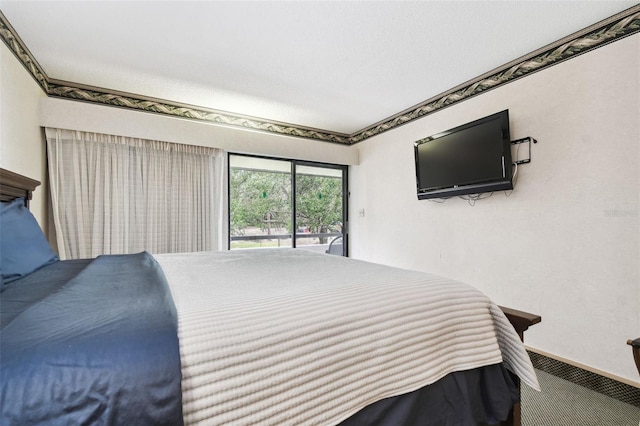 bedroom featuring access to exterior and carpet flooring