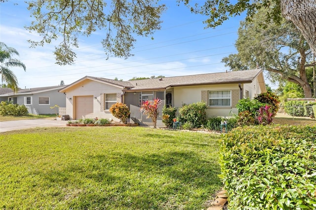 ranch-style house with a garage and a front lawn