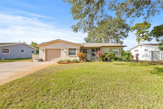 ranch-style house featuring a front yard and a garage