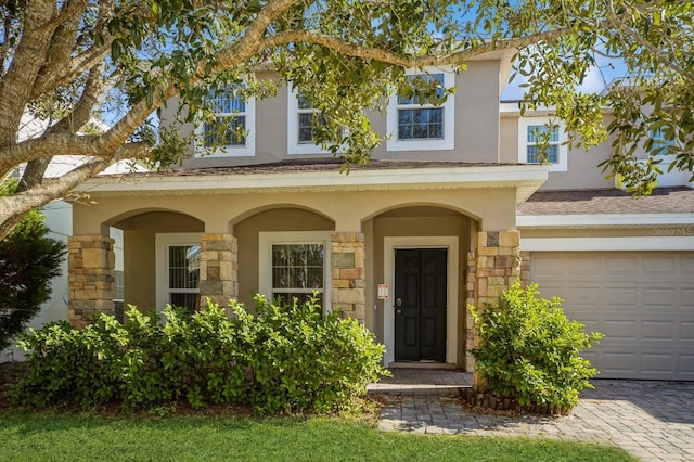 view of exterior entry featuring a garage