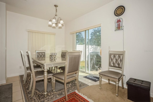 dining space with light tile patterned flooring and a notable chandelier