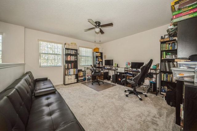 carpeted home office with ceiling fan