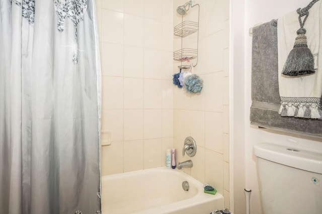 bathroom with toilet and shower / bath combo with shower curtain