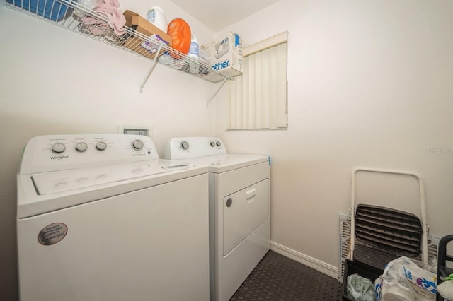 laundry room with washer and clothes dryer and dark colored carpet