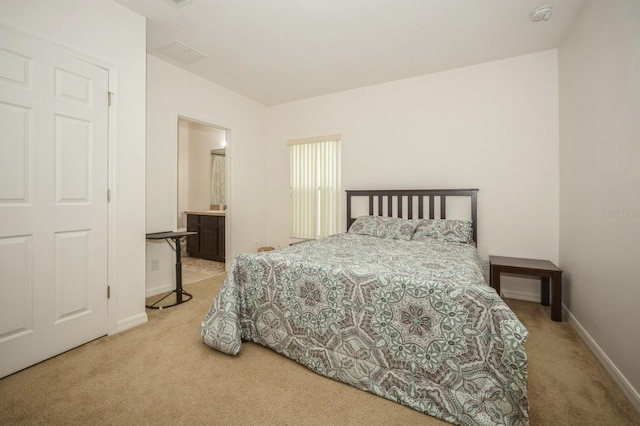 carpeted bedroom featuring ensuite bathroom