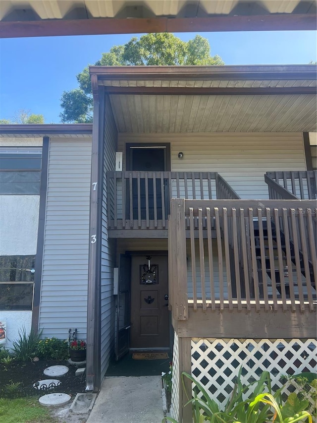 view of exterior entry with a balcony