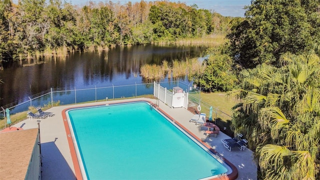 view of pool featuring a water view and a patio area