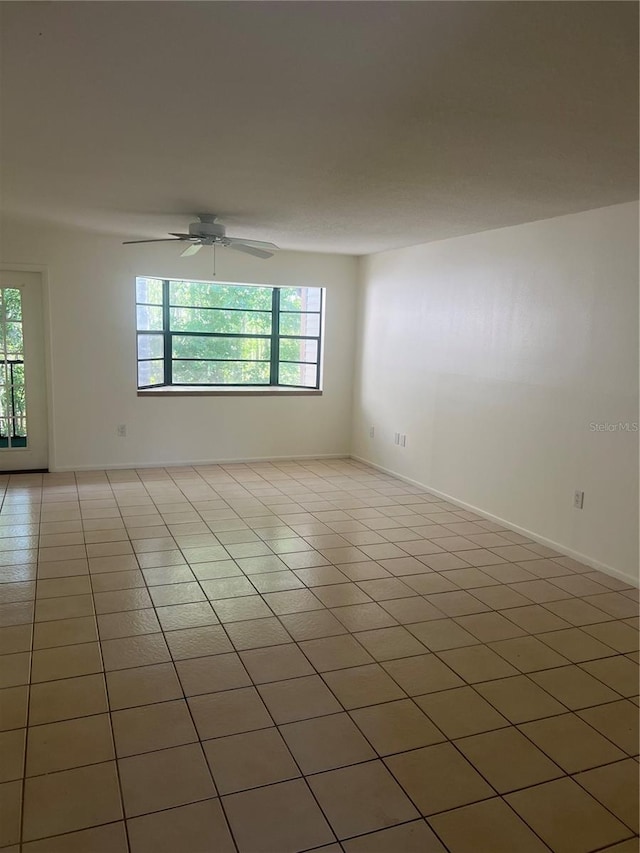 unfurnished room featuring plenty of natural light, ceiling fan, and light tile patterned floors