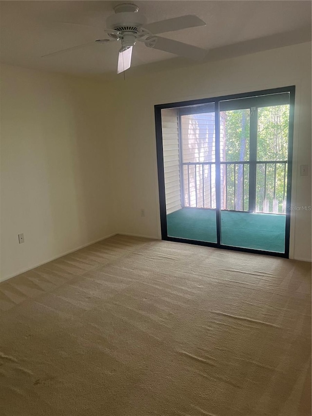 carpeted spare room with ceiling fan