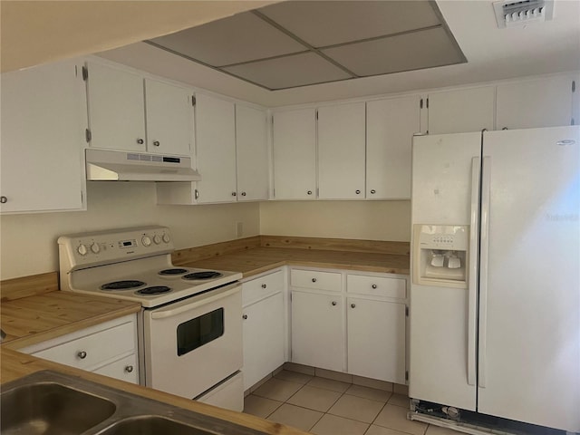 kitchen featuring white cabinets, light tile patterned flooring, and white appliances