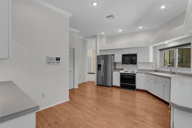 kitchen with sink, stainless steel refrigerator with ice dispenser, light wood-type flooring, white electric range oven, and white cabinetry