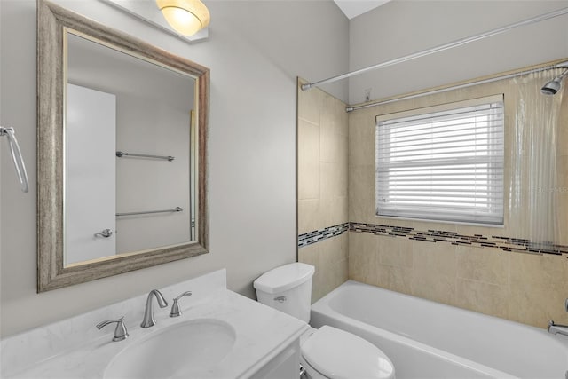 full bathroom with toilet, vanity, and tiled shower / bath