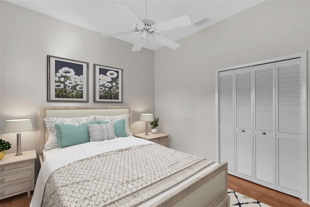 bedroom with a closet, light hardwood / wood-style floors, and ceiling fan