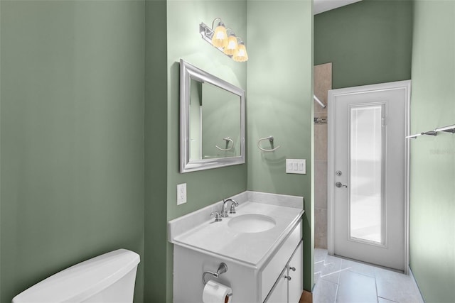 bathroom featuring tile patterned floors, vanity, and toilet