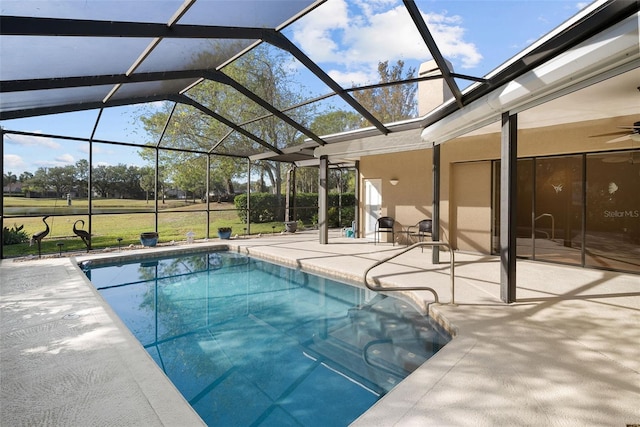 view of pool featuring glass enclosure and a patio