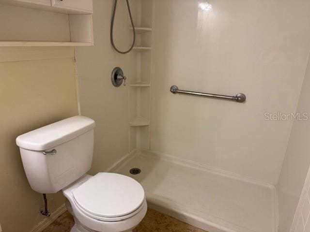 bathroom with a shower and toilet