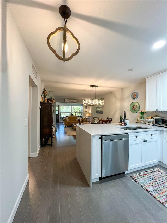 kitchen with dishwasher, dark wood-type flooring, white cabinets, sink, and hanging light fixtures