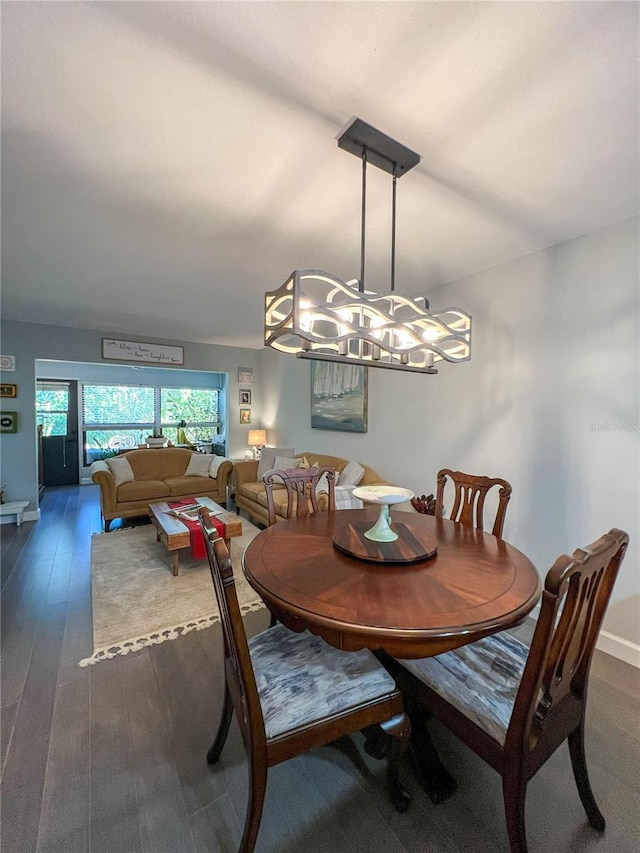 dining space with dark wood-type flooring