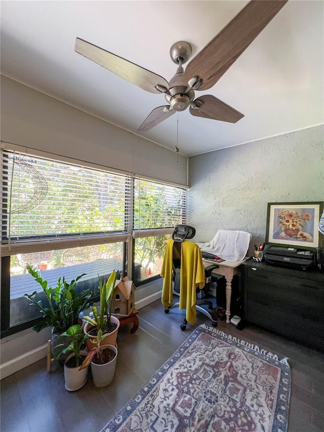 sunroom featuring ceiling fan