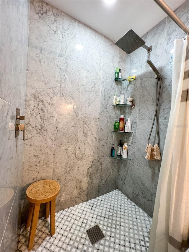 bathroom with a shower with curtain and tile walls