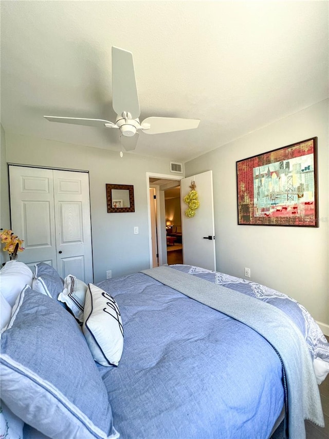 bedroom with ceiling fan and a closet