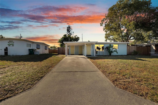 ranch-style house with a yard and a carport