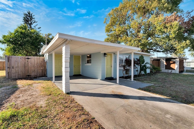 view of front of house with a front yard and a carport