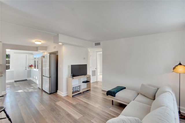 living room with light hardwood / wood-style floors