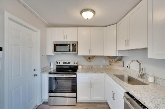 kitchen with white cabinetry, sink, and appliances with stainless steel finishes