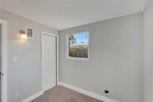 unfurnished bedroom with carpet flooring and a closet